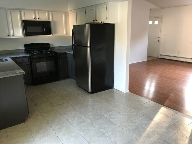 View from corner of house in dinning room overlooking kitchen and living room (front door) - 85 Wilson Ave