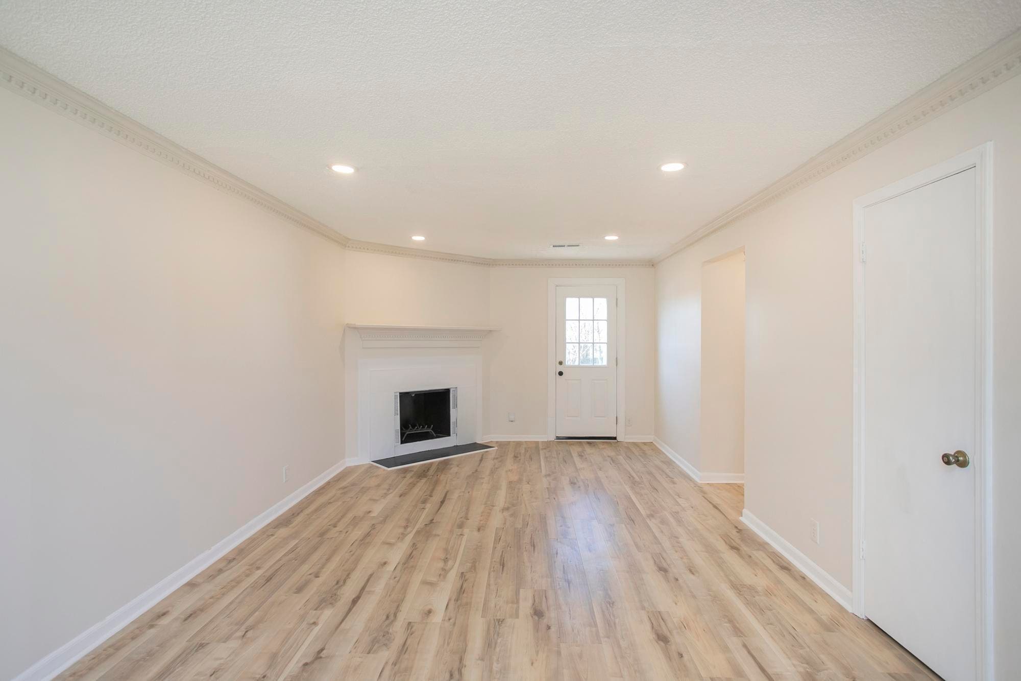 Bright and inviting living room featuring beautiful wood flooring and abundant natural light. - 105 Jacksons Retreat Ct
