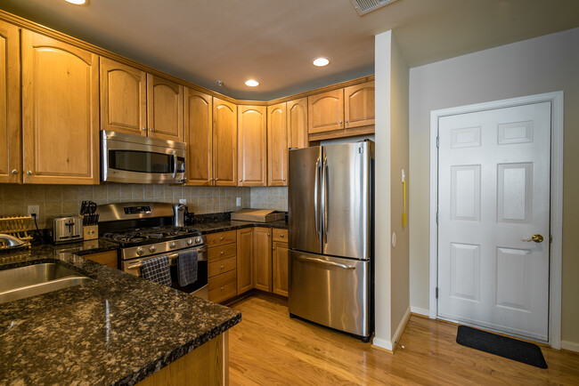 Spacious kitchen with stainless steel appliances and easy access to garage on the right - 22785 Settlers Trail Terrace