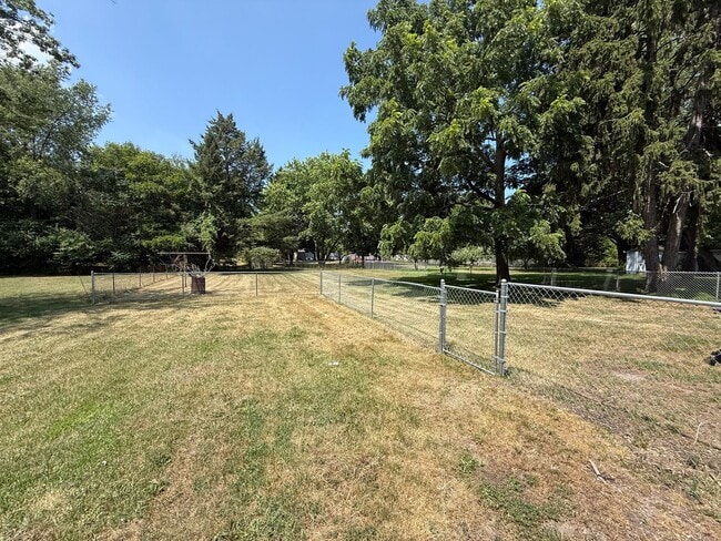 Building Photo - Spacious 4-Bedroom Home with Fenced Yard &...