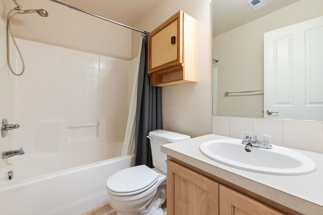 Building Photo - Lovely and bright townhouse with a hard wood flooring throughout, a 2 car garage, AC & more!