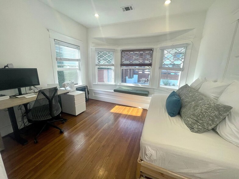 Bright second bedroom with large bay windows and built-in window seat. - 6000 Carlton Way