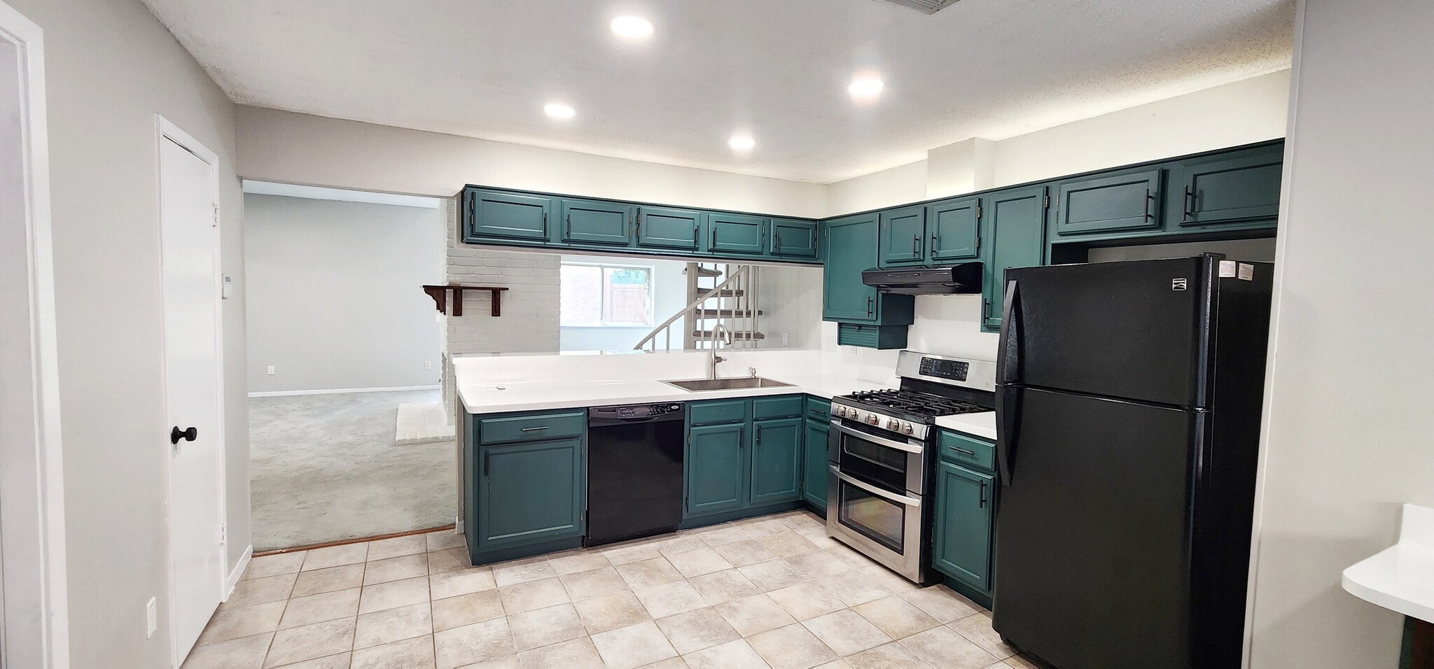 Beautiful contemporary forest green and white kitchen with ambient lighting above cabinets. - 4722 Rainbow Run