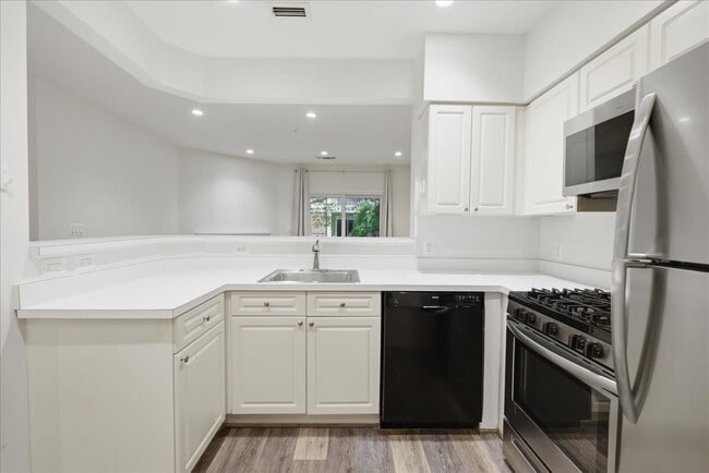 Building Photo - Commuter’s Paradise! Ground-Level 2BR Condo  Welcome home to this stunning, sun-filled 2-bedroom ...