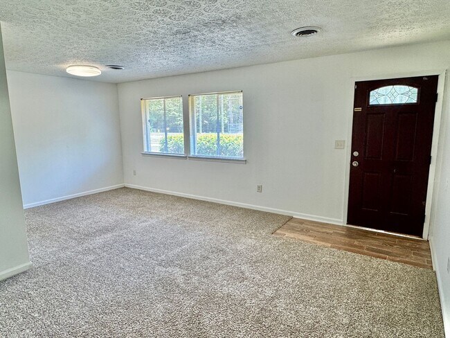 Building Photo - Cozy Meets Spacious: 4BR/2BA with Bonus Den & Patio