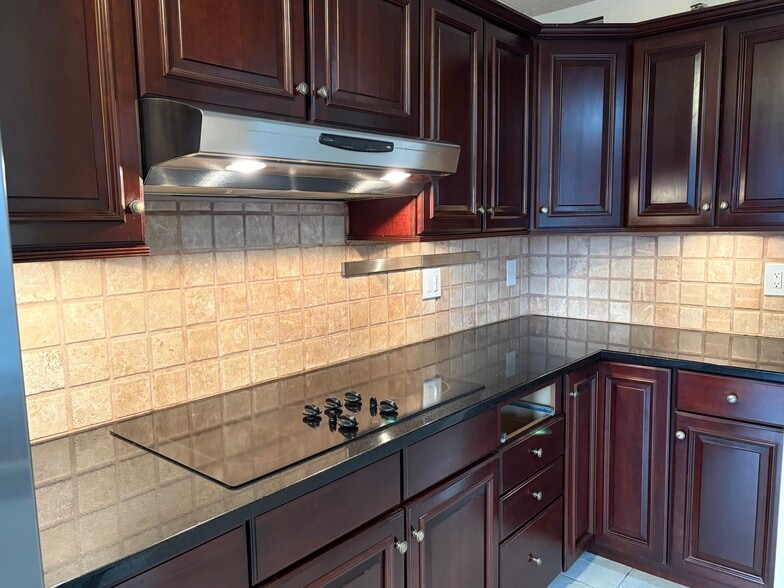 Granite surfaces with stainless appliances and solid wood cabinetry. - 25 Rockledge Ave