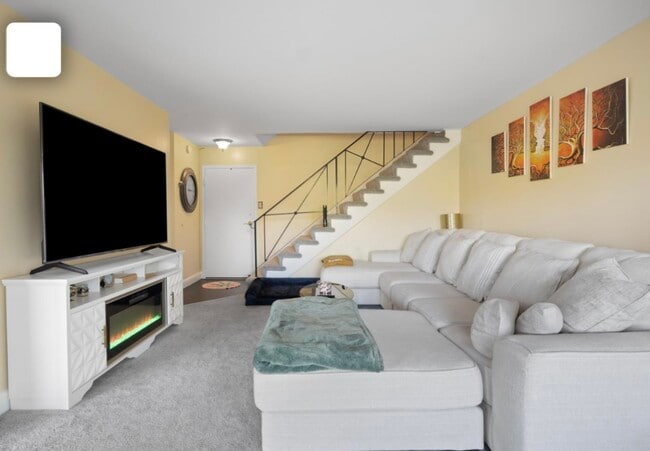 In the living room, enjoy plush wall to wall carpet and tons of natural sunlight - 301 N Beauregard St