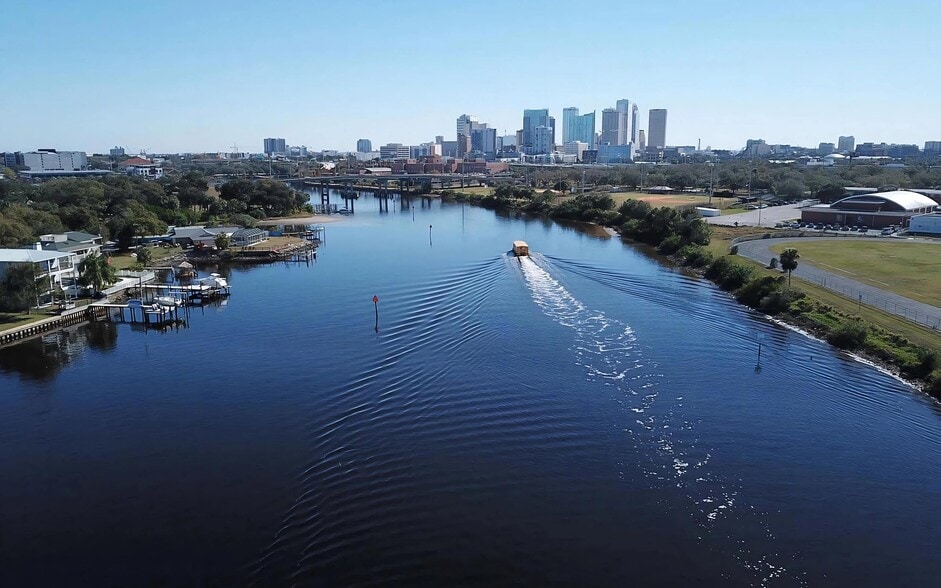 The river runs straight into downtown, with the Riverwalk following the bank. - Anchor Riverwalk