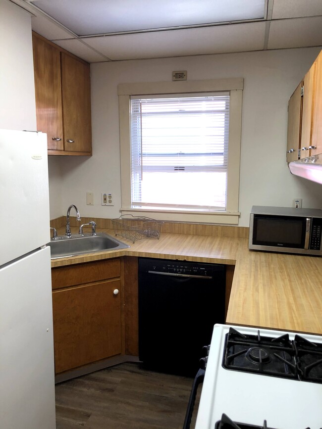 Kitchen with dishwasher, stove, and fridge - 25 5th Ave