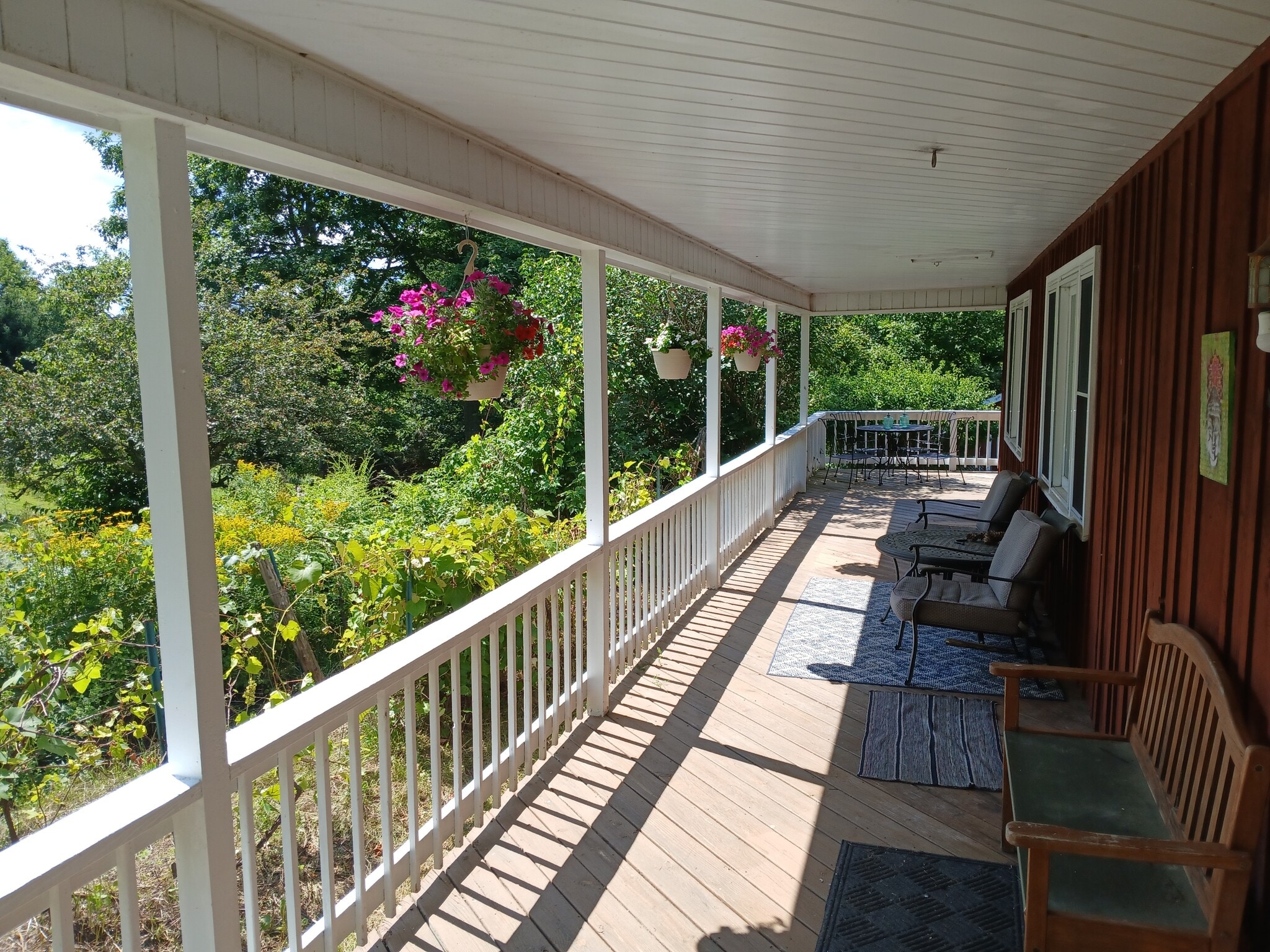 South facing front porch with view of garden, lawn and pond - 115 Delta Dr