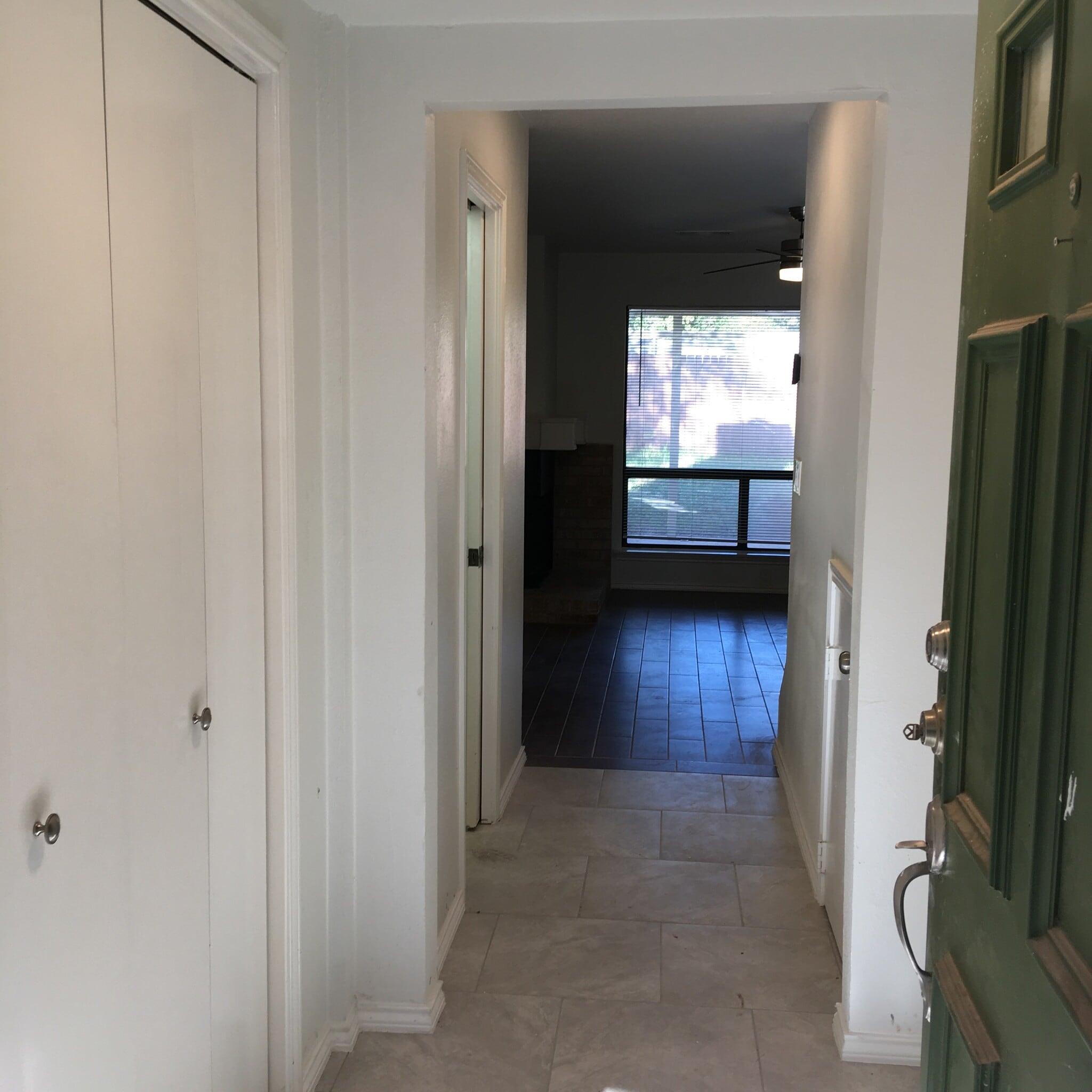 Entryway with large coat closet, storage under the stairs and half bath. - 8604 Willowick Drive