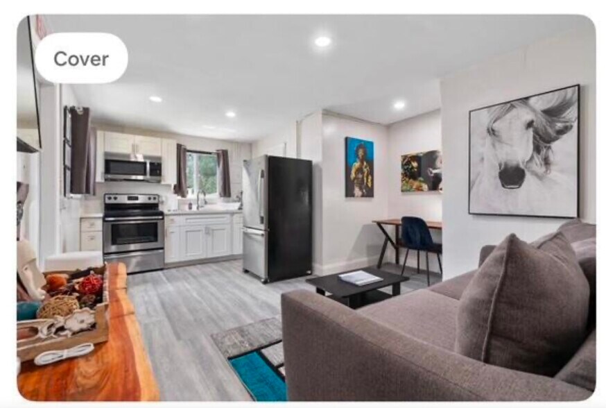 Cozy living room with designated study space and spacious living area. - 529 NW 15th Way