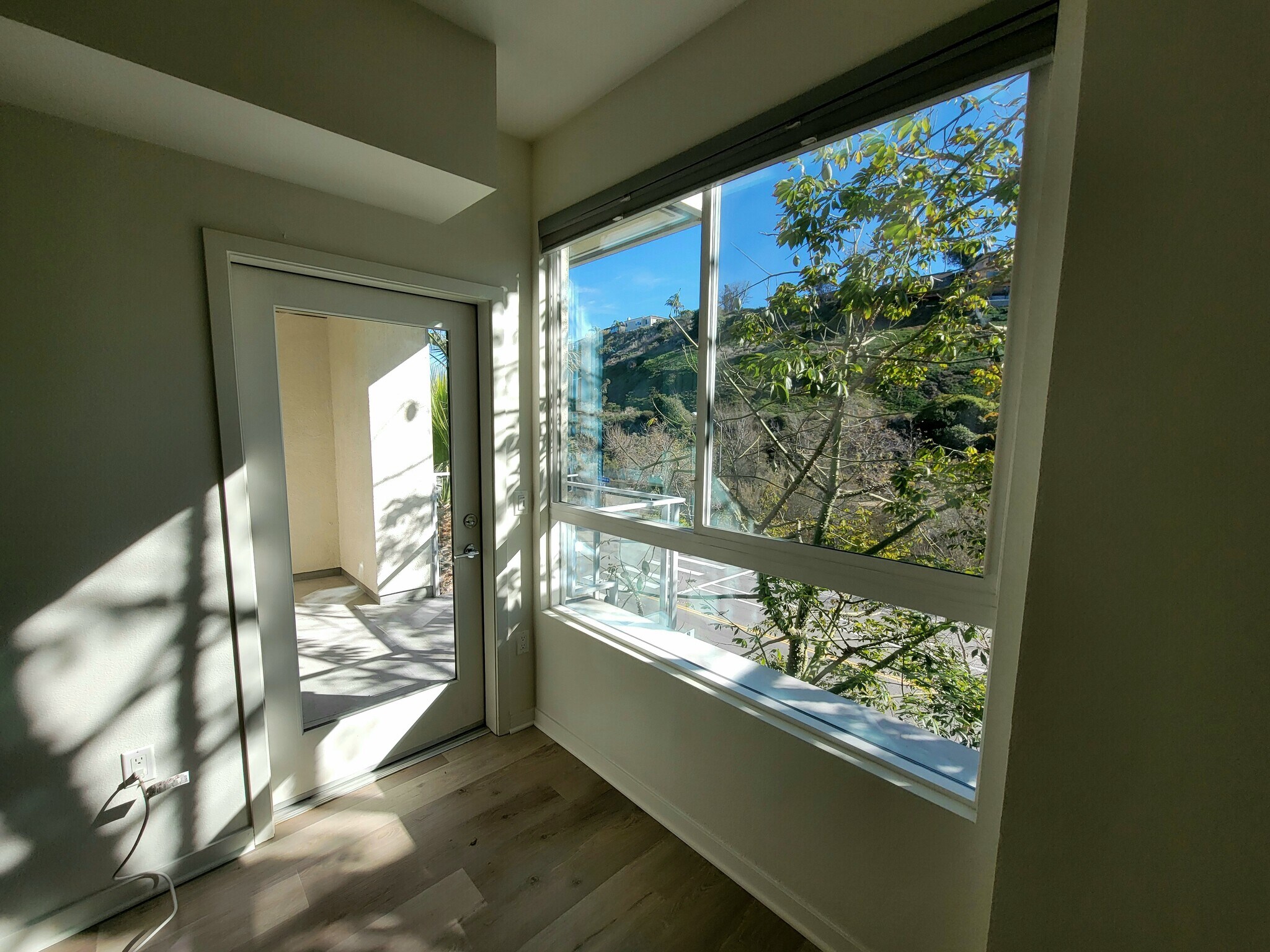 Living Room Facing Bluff Creek Drive and Door to Balcony - 12655 Bluff Creek Dr
