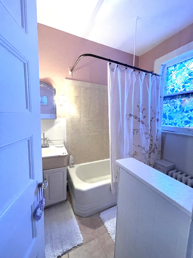 Sunny Bathroom with traditional deep bathtub - 42 Central Ave