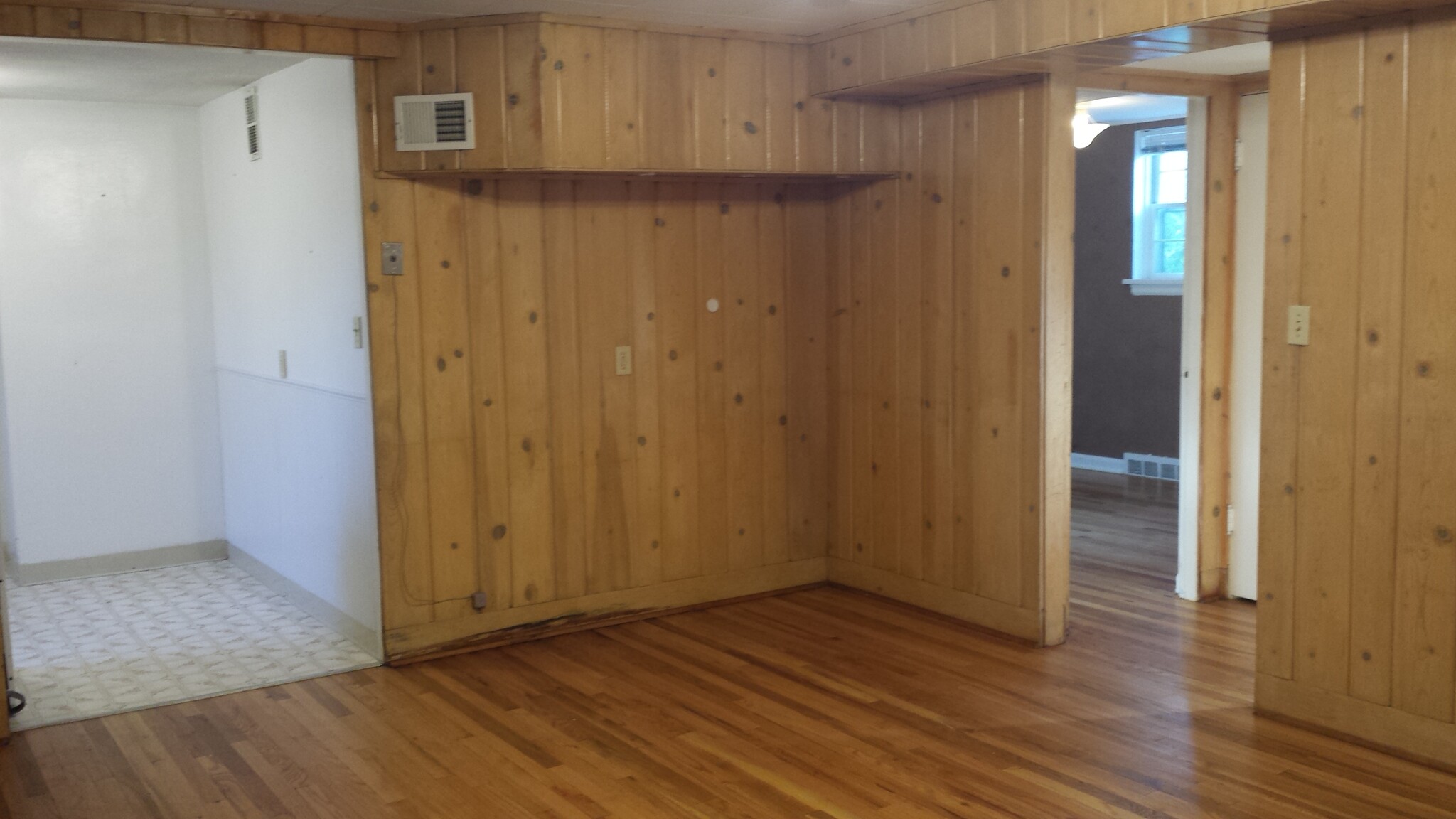 Living room with kitchen on the left and hallway/south bedroom on the right - 901 Country Club Ave