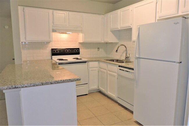 There is a microwave in the corner and replace a nice electric stove there there is a TV on the top - 3900 Woodchase Dr