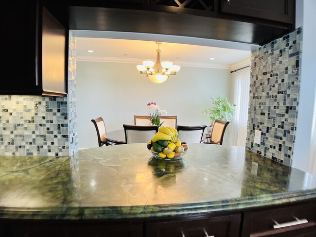 Kitchen open to dining area - 6301 Coldwater Canyon Ave