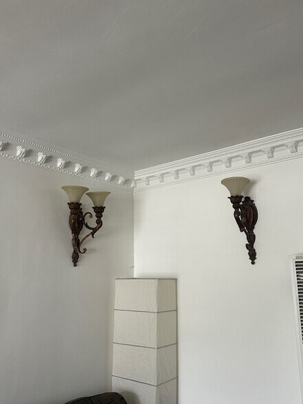 Living room wall sconces with beautiful crown molding. - 1859 1/2 Pandora Ave