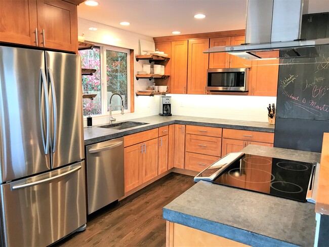 Custom kitchen with concrete counter tops and slate chalkboard wall - 6549 40th Ave NE