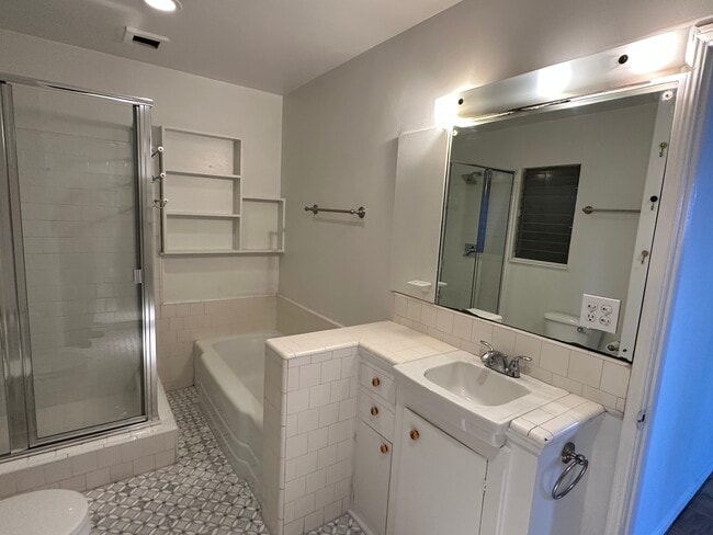 Bathroom with tub and shower. - 2021 Rosilla Pl