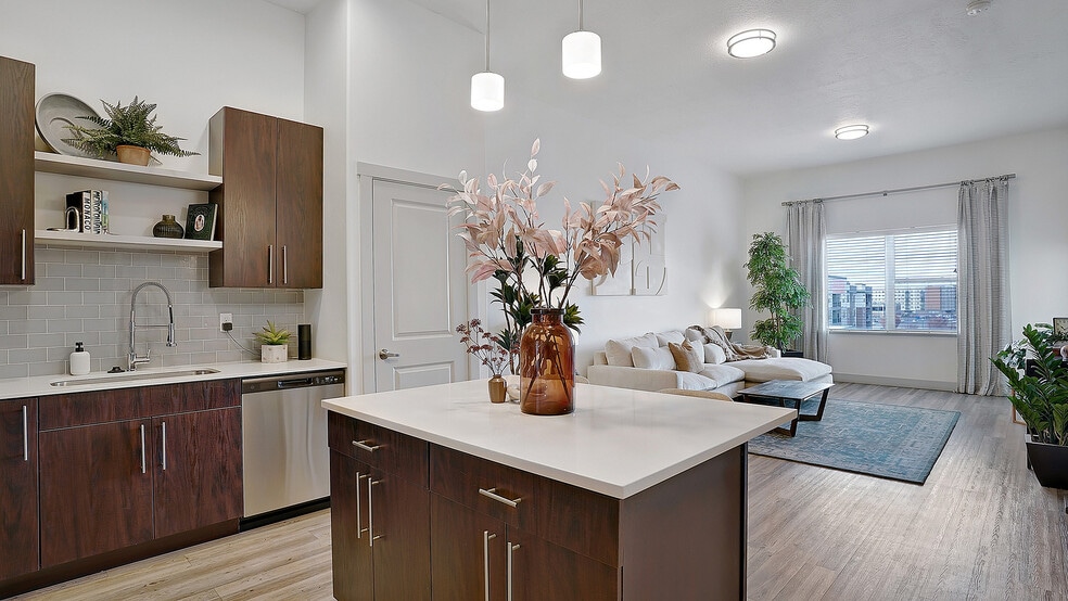 Modern kitchen island with open sightlines to the living space. - Parkway Lofts