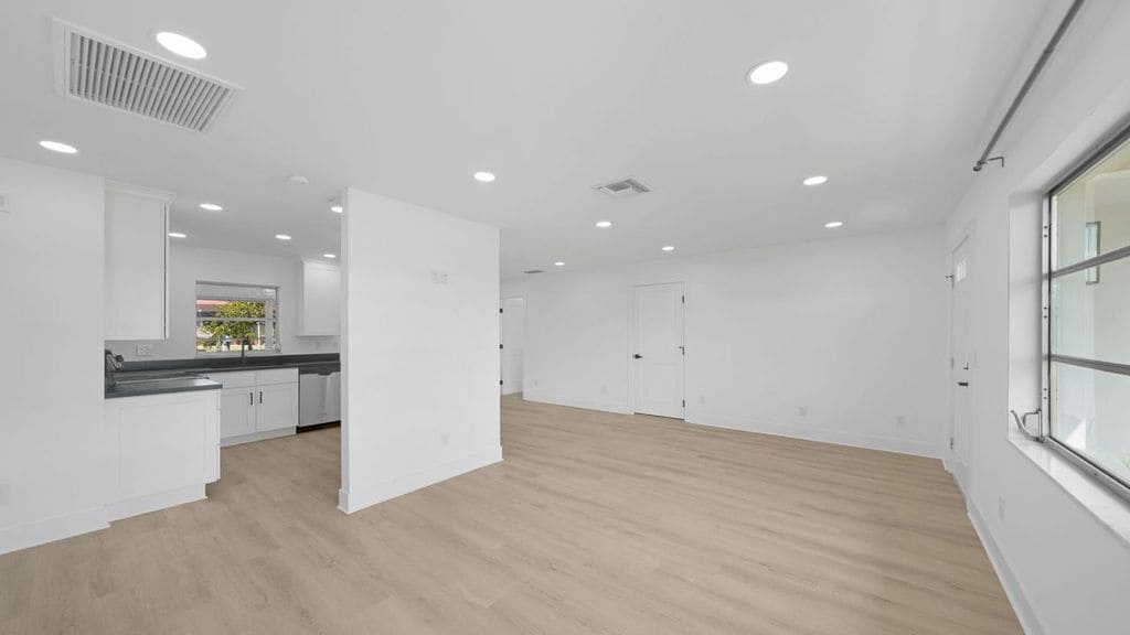 View of living room and kitchen and door into garage - 5308 Darby Ct