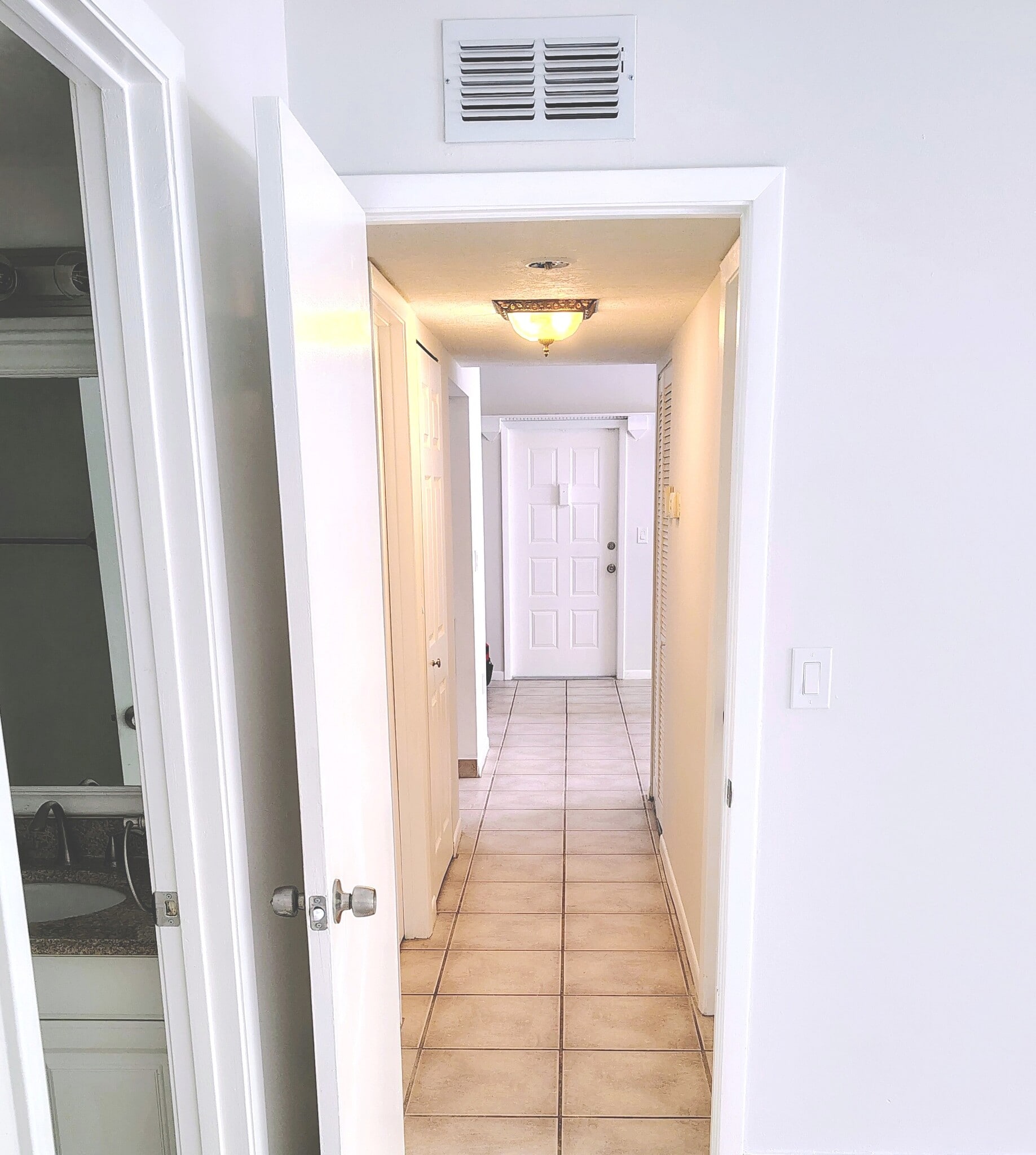 Hallway with W/D on left, A/C and water heater on right. - 1353 Pine Ridge Cir E