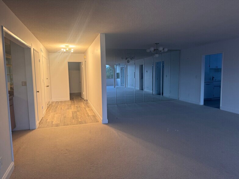 Entry hall back into 2 bedrooms; dining room with upgraded chandelier - 8701 Delgany Ave