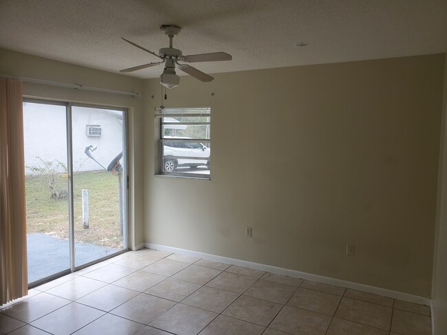 Large bedroom with sliding doorwall and patio outside for barbecue - 6538 W Norvell Bryant Hwy