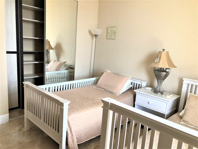 Second bedroom with two separate beds which can be converted into the bank bed. Baby crib available - 15901 Collins Ave