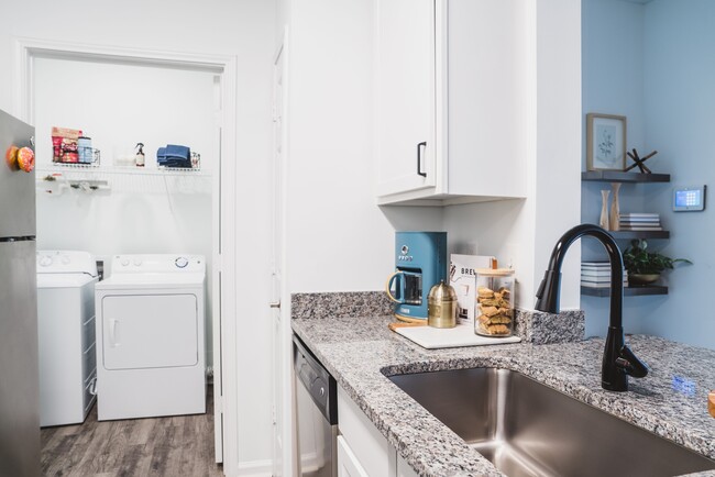 Renovated kitchen with stylish designer tile backsplash and granite countertops - Alister Lake Lynn