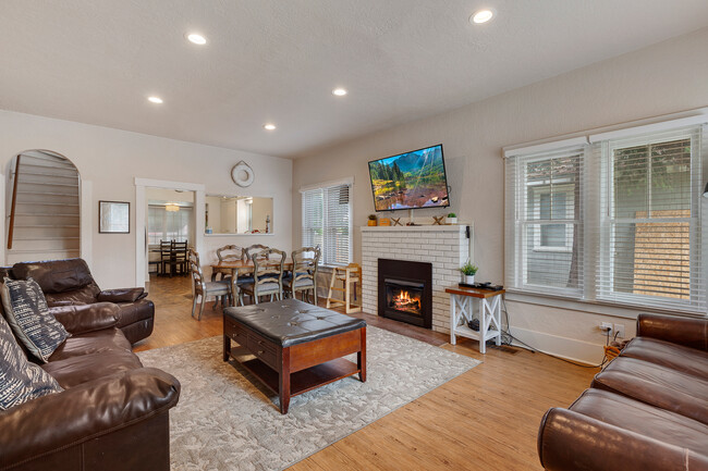 Large open living room with fireplace and two couches. - 717 E Lakeside Ave