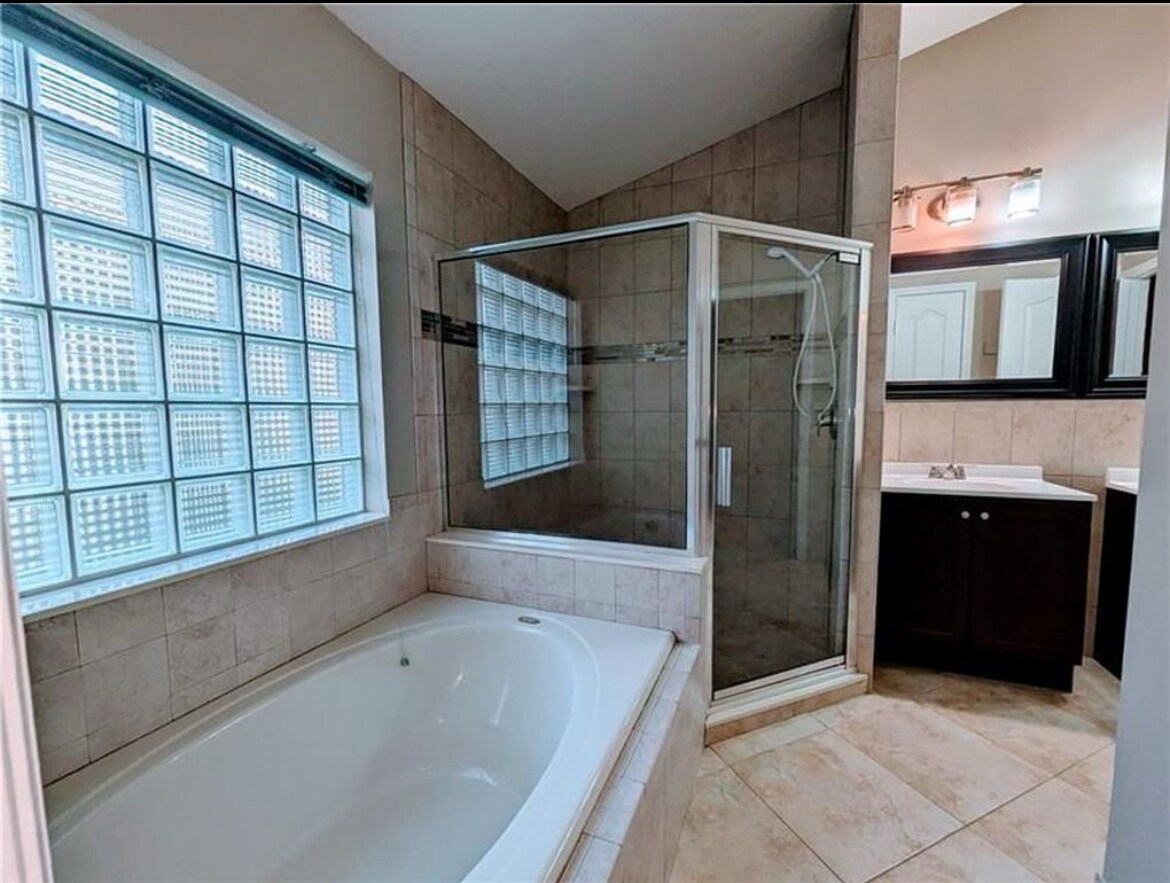 Deep soaking tub with new floor to ceiling tile - 562 SW Saint Martins Cv