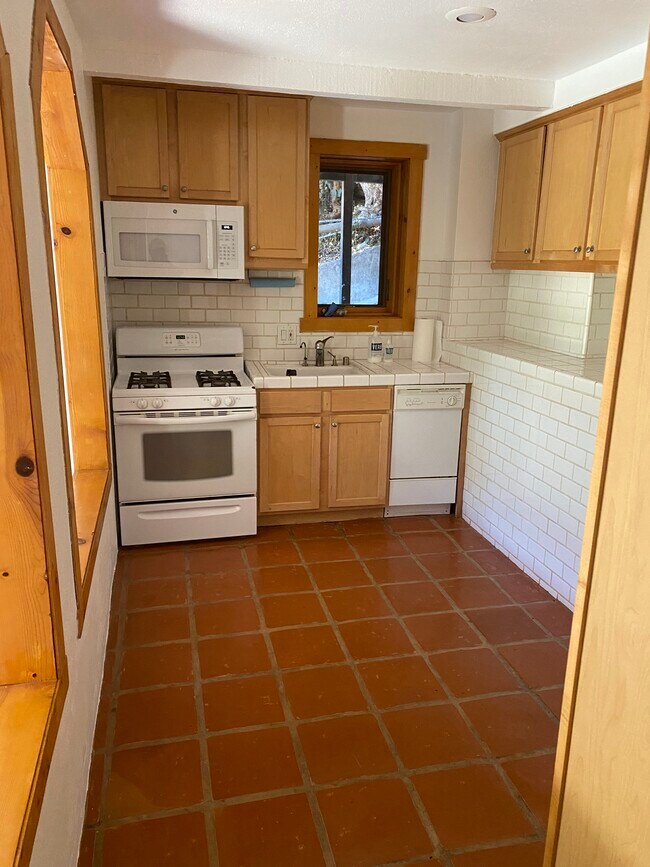 Kitchen with dishwasher. All tile. - 6206 Temple Hill Dr