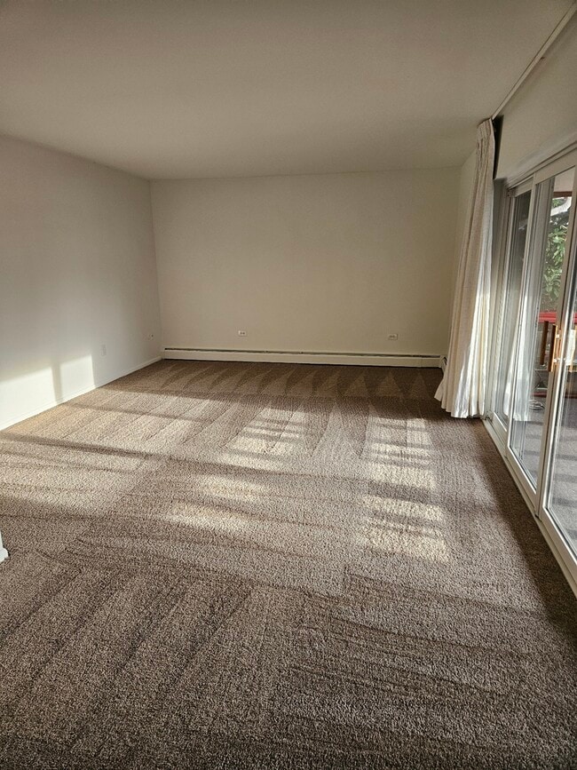 Step into a spacious and bright living area, perfect for relaxation and entertainment. - Lake Club Apartments