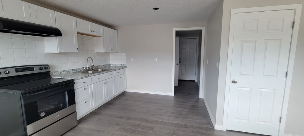 Kitchen leading to the hallway with bedroom the bedroom to the right and bathroom to the left - 254 E 500 N