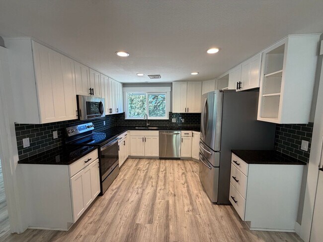 Building Photo - Spacious 4BR/3BA Home with Deck, Fenced Yard & Garage