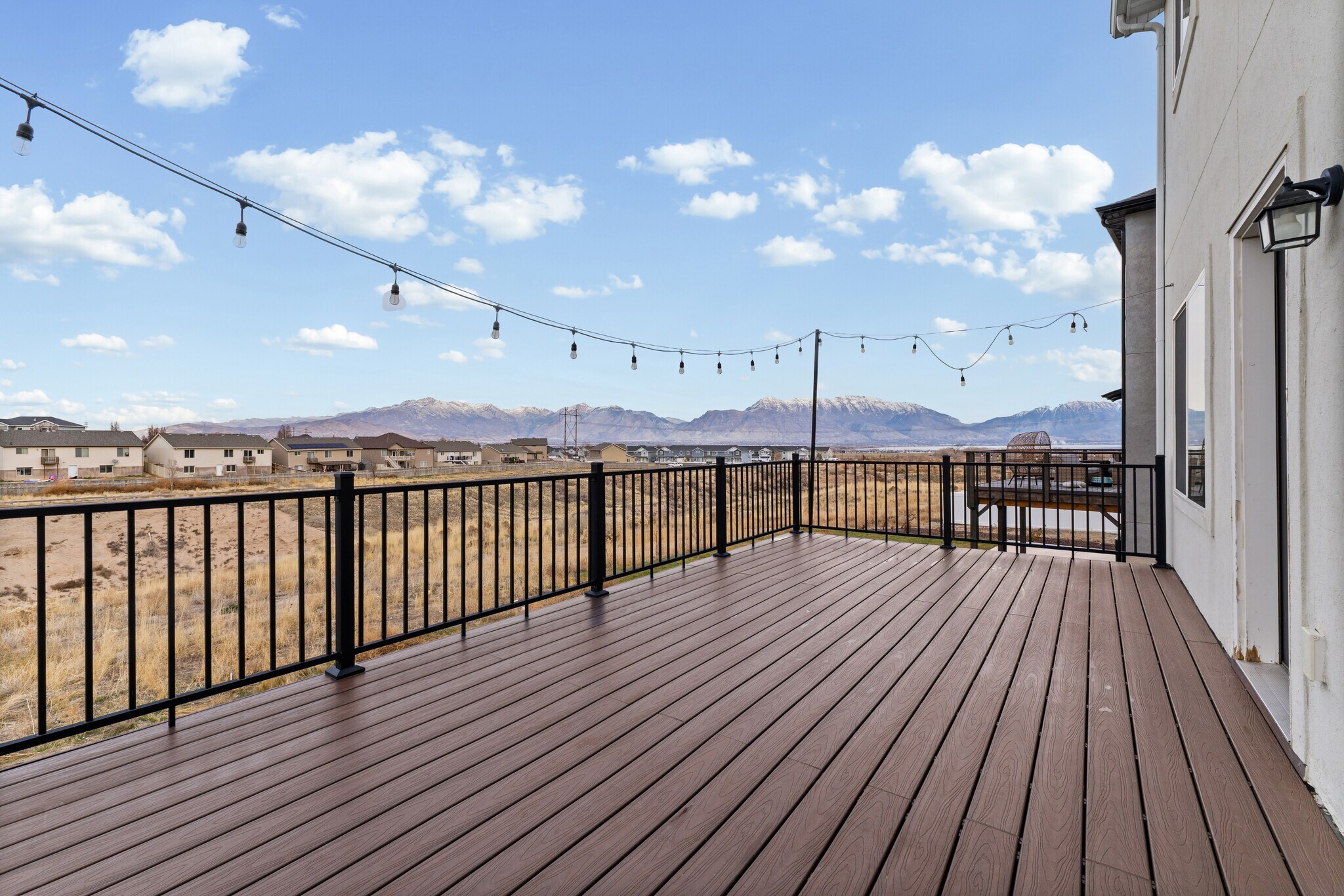Deck/deck view - Trex deck with iron railing and lights. Beautiful view of the valley and mountains - 4877 E Silver Ridge Rd
