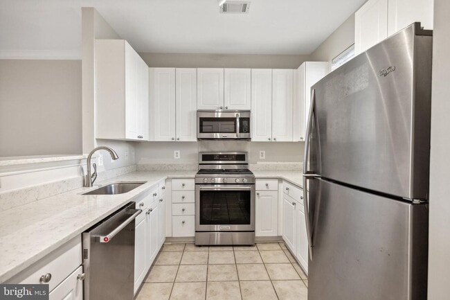 Building Photo - This townhouse style condo is located across the street from the Vienna Metro Station (Orange Line).