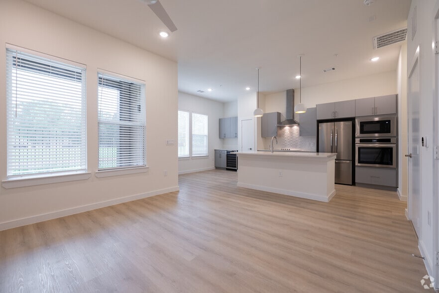 1BR, 1.5BA - 812SF - Living room, Kitchen, Dining Room - Oasis at Woodland