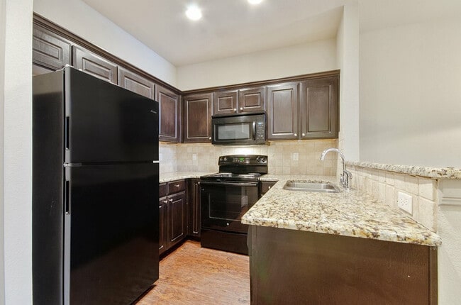 State of the art kitchen with black appliances - Tinsley Place