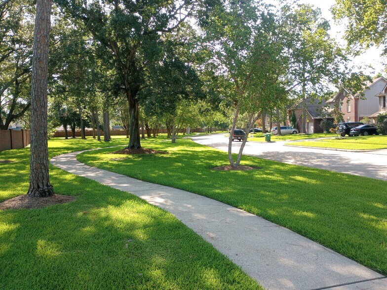 Another view of the walking trail across the street with shade trees all along the path - 14611 Sun Harbor Dr