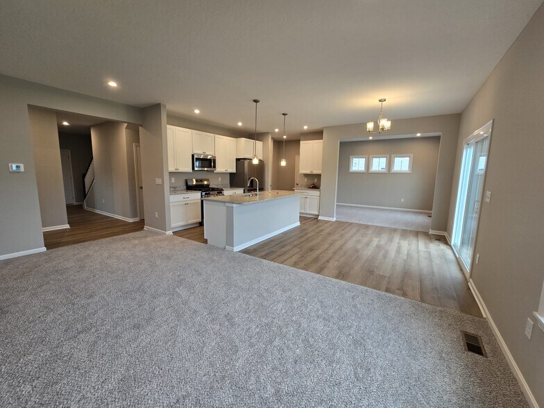 Modern open space style with 10 ft ceiling, stainless steel appliances and a family room on end - 8985 Hawk Hill Way