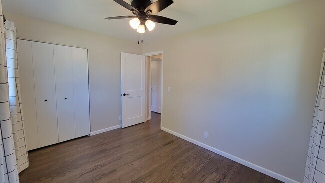 Bedroom 2. Refinished hardwood floors, 4 ft wide closet, new windows and ceiling fan. - 6305 49th Ave