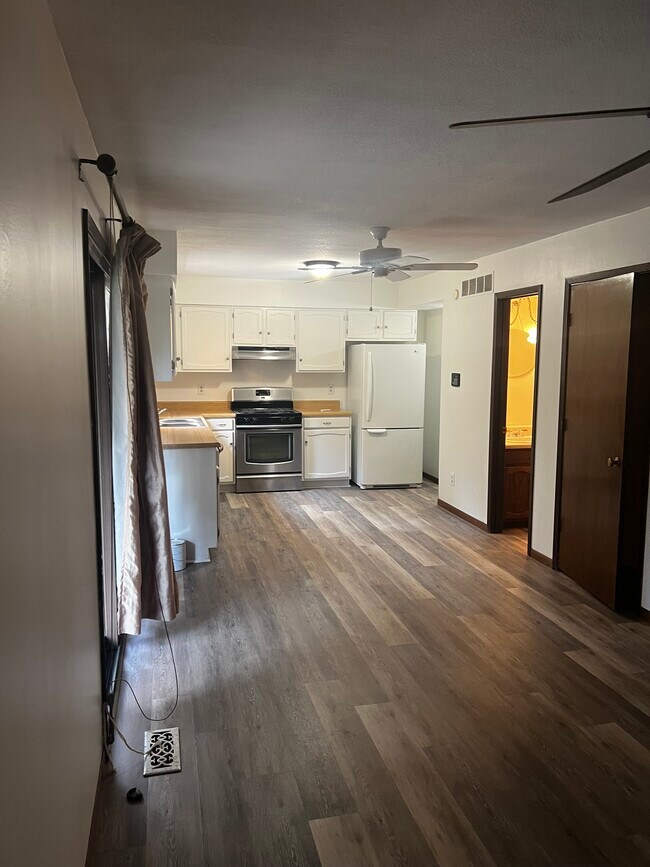 Dining room and kitchen. New floorings and paint throughout home - 5341 SW 15th Ct