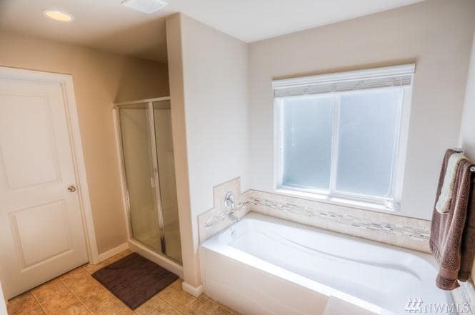 Master bath, shower features seats. - 8828 Jayden Ln NE