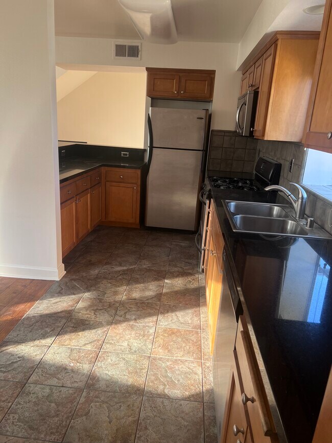 kitchen with regrigerator - 14907 Moorpark St
