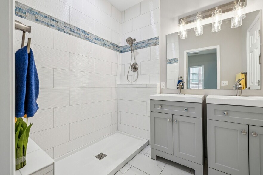 Ensuite bathroom with a large, custom, spacious shower, two vanities and a water closet - 2301 Seifried St