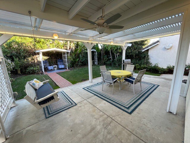 Patio with lights, swing, BBQ and table - 10545 Kemerton Rd