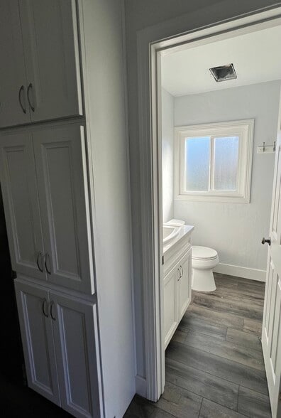 Hallway Storage and Bathroom with window, sink, toilet, and full size stand up shower. - 4960 34th St